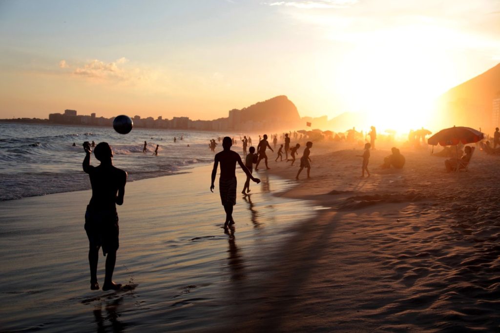 Dzieci grają w pilkę nad brzegiem morza w Brazylii